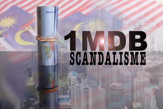1 Malaysian Ringgit banknotes with incription 1MDB over a blur background of Malaysia flags and cityscape.