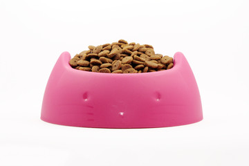 Dry cat food in pink bowl isolated on white
