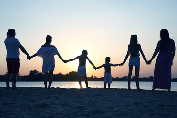 Fototapeta na wymiar Silhouette of family on sunset background