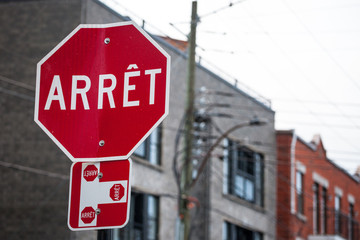 Quebec Stop Sign, obeying by bilingual rules of the province imposing the use of French language on...