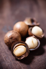 Macadamia nuts on wooden background