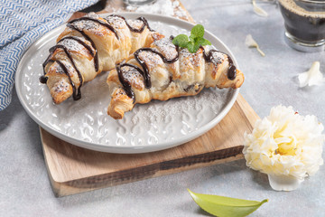 Delicious continental breakfast with fresh flaky french croissants and coffee, close up on the croissants