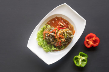 stuffed peppers, paprika on a white plate on a dark background