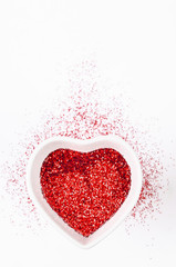 Heart shape made of red glitter.