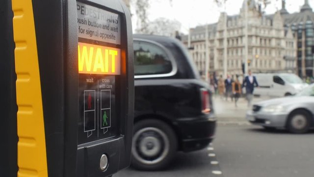 Pedestrian traffic light at Parliament Square with Nelson Mandela statue in background.