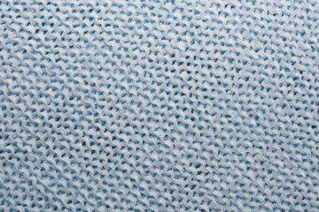 The texture of the knitted blue fabric for the background   