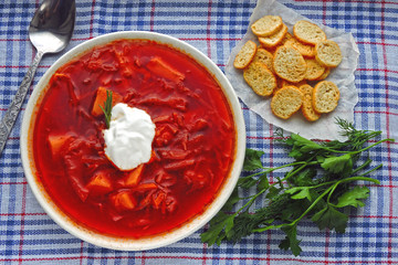 Fresh homemade tomato soup with croutons and herbs. Borscht.