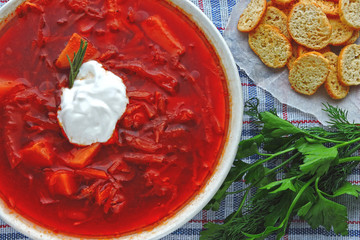 Fresh homemade tomato soup with croutons and herbs. Borscht.