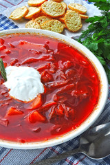 Fresh homemade tomato soup with croutons and herbs. Borscht.