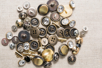 Metal sewn buttons on linen natural fabric 