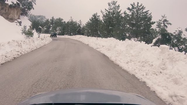 Driving on a snowy mountain road to Ziria ski center in Greece.
