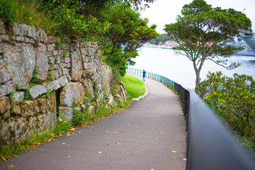 Beautiful Evening beach along the Park and Battleship in the background. At Mrs Macquarie's Chair in The Domain, Sydney, Australia