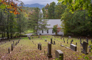Little white country church at the break of fall. - 246722344