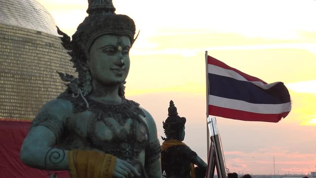 BANGKOK,  THAILAND - CIRCA OCTOBER 2018 : THAILAND NATIONAL FLAG and statue in sunset. Located at WAT SAKET.