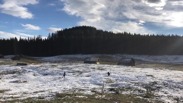 A couple have winter fun on snow, timelapse
