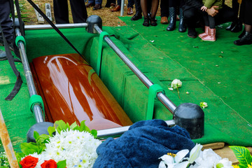 People funeral putting down the coffin at a funeral