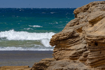Fototapeta na wymiar Rocks Against The Surf