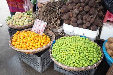 Peach Orange Lime Ginseng and  Cassava on basket in Morning Market.
