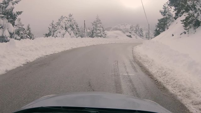 Driving through the fog on a snowy mountain road to Ziria ski center in Greece.