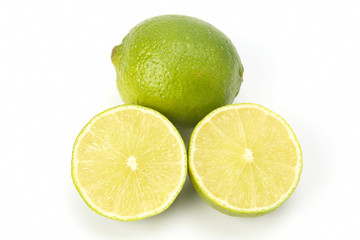 Cut citrus fruit of green lemon on white background