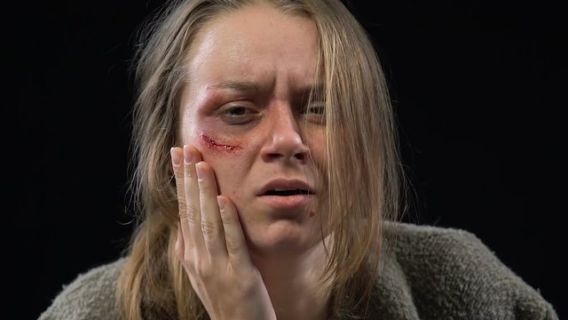 Abused woman crying hard, feeling desperate and defenseless, spousal abuse