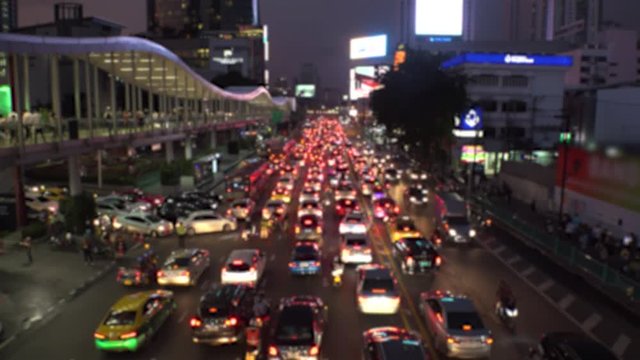 BANGKOK,  THAILAND - CIRCA OCTOBER 2018 : Blurred view of HEAVY RUSH HOUR TRAFFIC JAM near CHIT LOM train station.  Many CAR, BUS, TAXI, MOTORBIKE and TUK TUK on the road.