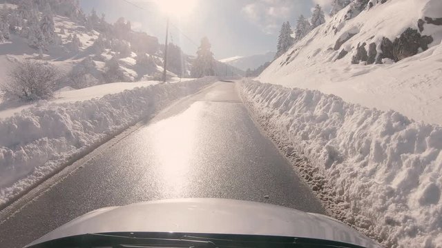 Driving on a snowy mountain road, sunny weather. Approaching Ziria ski center in Greece.