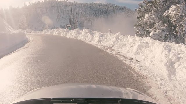 Driving through the fog on a snowy mountain road to Ziria ski center in Greece.