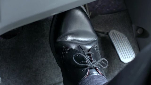 Man driving with pedals of a car