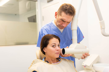 Dentist taking a teeth radiography to a patient