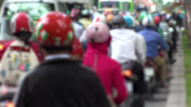 HO CHI MINH,  VIETNAM - CIRCA NOVEMBER 2018 : Blurred view of HEAVY RUSH HOUR TRAFFIC.  Many MOTORBIKE RIDERS on the busy road.