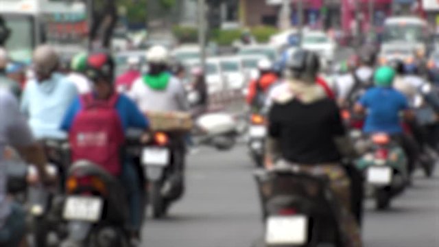 HO CHI MINH,  VIETNAM - CIRCA NOVEMBER 2018 : Blurred view of HEAVY RUSH HOUR TRAFFIC.  Many MOTORBIKE RIDERS on the busy road.