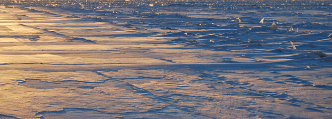 The first ray of the sun on the ice on the river Irtysh