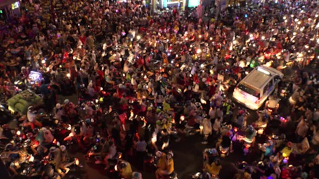 HO CHI MINH,  VIETNAM - CIRCA OCTOBER 2018 : Aerial view of CROWD of PEOPLE and MOTORBIKES at BUI VIEN STREET in blurred.