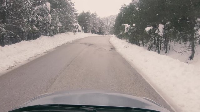 Driving on a snowy mountain road to Ziria ski center in Greece.