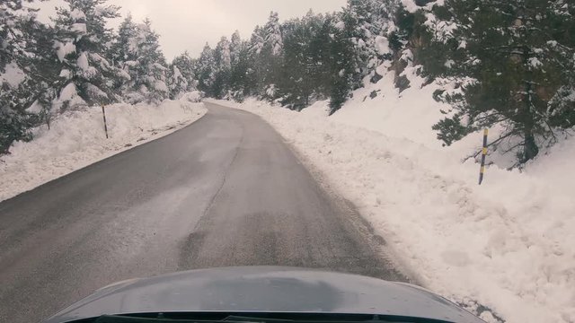 Driving on a snowy mountain road to Ziria ski center in Greece.