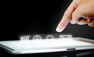 hands of people are using the tablet to find information and to entertain on black background.Concept of technology