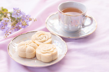Home-made cheese tart on vintage ceramic plate with hot tea on sweet pink tone