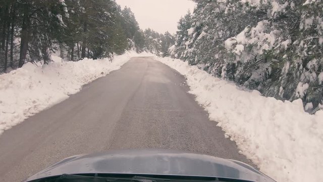 Driving on a snowy mountain road to Ziria ski center in Greece.