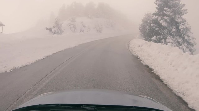 Driving through the fog on a snowy mountain road to Ziria ski center in Greece.