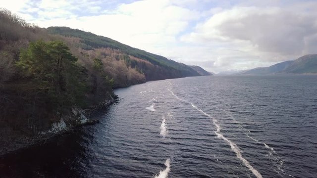 Aerial footage of Loch Ness looking towards Fort Augustus on a sunny day, Scottish Highlands, Scotland