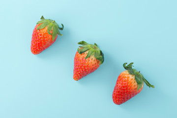 Strawberries on light blue background, flat lay