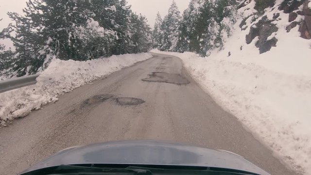 Driving on a snowy mountain road to Ziria ski center in Greece.