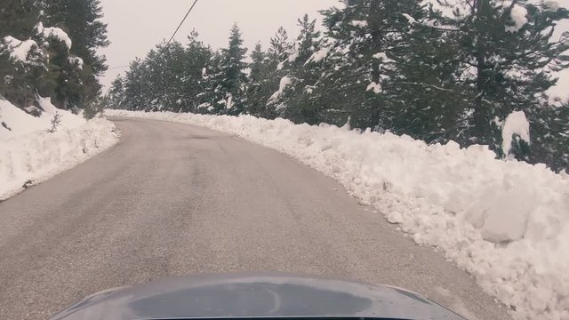 Driving on a snowy mountain road to Ziria ski center in Greece.