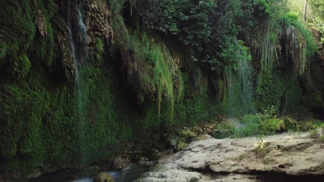 Aerial view of the Kursunlu waterfalls being approached. Stunning vegetation with waterfalls.