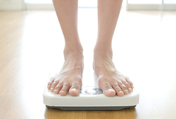 Legs of men standing on scales weight. Concept of health and weight loss.