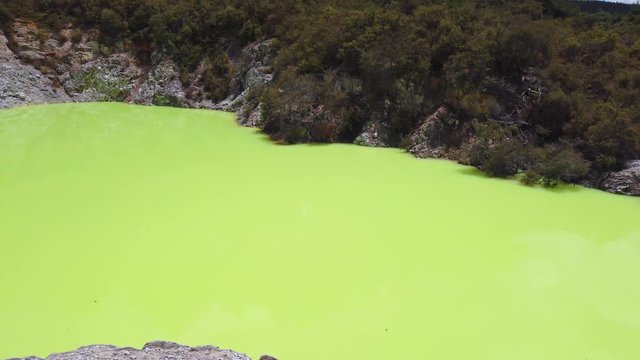 Green volcanic pool "the Devil's Bath" in thermal park, Rotorua, New Zealakd. 4k Pan right