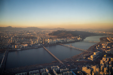 Naklejka premium Aerial view cityscape of Seoul, South Korea. Aerial View Lotte tower at Jamsil. View of Seoul with river and mountain. Seoul downtown city skyline, Aerial view of Seoul