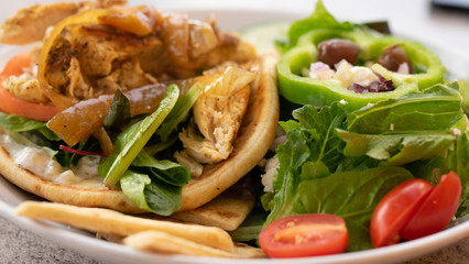 Chicken pita giro and Greek salad.   Healthy eating concept images.