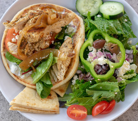 Chicken pita giro and Greek salad.   Healthy eating concept images.